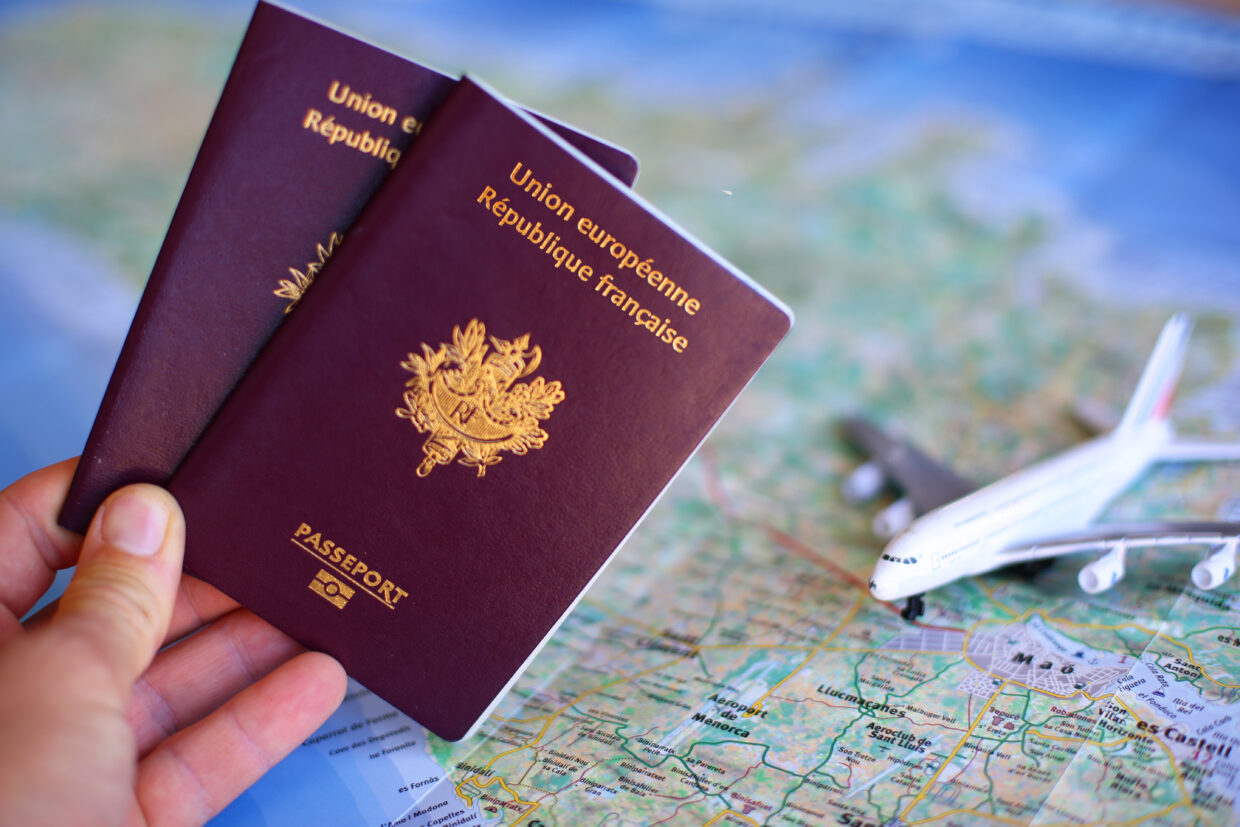 French passport with blurred map in background – travel concept