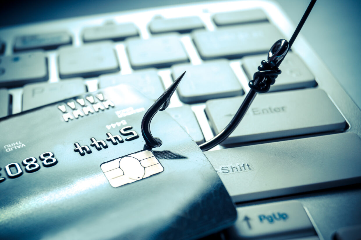 credit card phishing – piles of credit cards with a fish hook on